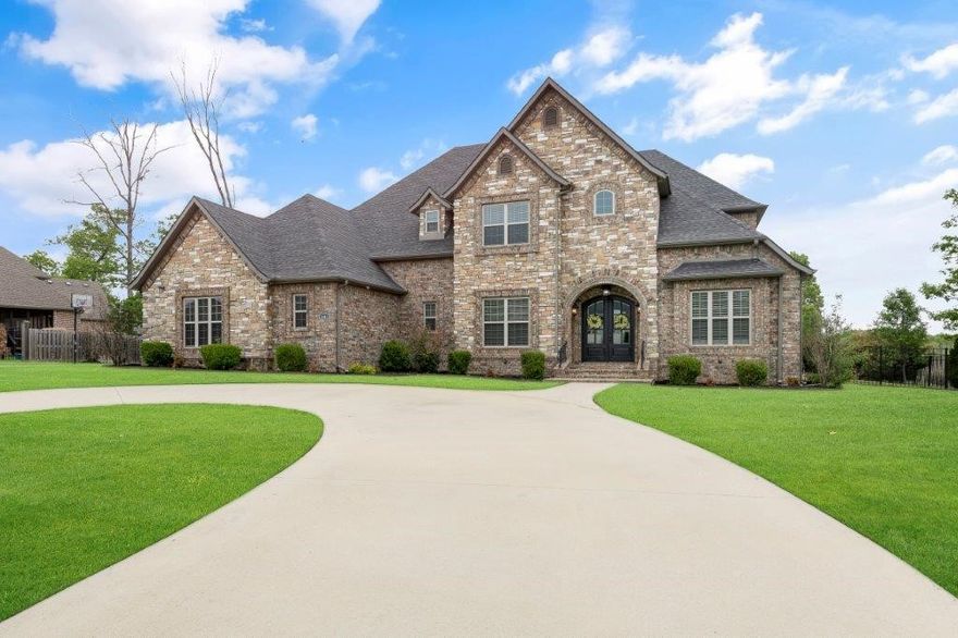 Custom home in the coveted Versailles neighborhood with a rare 1-acre flat fenced lot. New fully automated gunite pool and spa with low maintenance mineral system. This home has amazing curb appeal with circular drive & side driveway leading to the 3+ car garage w/epoxy flooring. You will love the bright & open floorplan w/gorgeous hand-scraped hardwoods. The kitchen is open to the living room & fully equipped with professional-grade Thermador appliances, gorgeous counters and large walk-in pantry. The main floor includes dining room, formal living room, office/flex space with access to backyard, covered porch, powder bath & large laundry room. Master bed and bath are on the main level w/2 large walk-in closets and direct access to backyard. Upstairs boasts 4 more bedrooms, one of which is perfect for a game/bonus room with walk-in attic storage. Each bedroom has private ensuite bath & walk-in closet. The Versailles neighborhood is highly desired located off highway 72 & only 4 miles to downtown Bentonville.