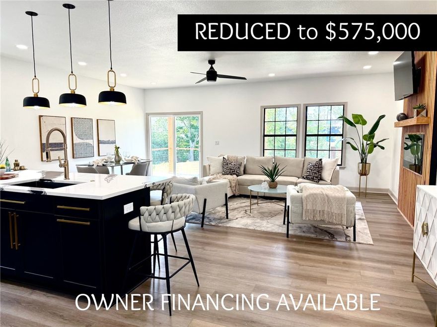 Owner Financing! Steps from Downtown Rogers! New construction! This contemporary home has it all. Offering the perfect blend of modern comfort with all the extras (LED mirrors in the bathrooms, quartz countertops, and unique accent walls with wainscotting) you will feel the connectivity of the space the moment you walk in. It has an open floor plan with natural light pouring in that gives off a warm and  welcoming energy. And with 4 bedrooms and 3 full bathrooms there's a sense of balance - enough space for privacy yet still cozy enough to call home. If you're looking a great neighborhood you have come to the right place. The residents of Downtown Rogers are quick to invite you in to their tight community with welcoming arms. Walkable distance to local coffee shops, boutiques, outdoor concerts, and bike trails - you may never want to leave. And remember.... owner financing available.