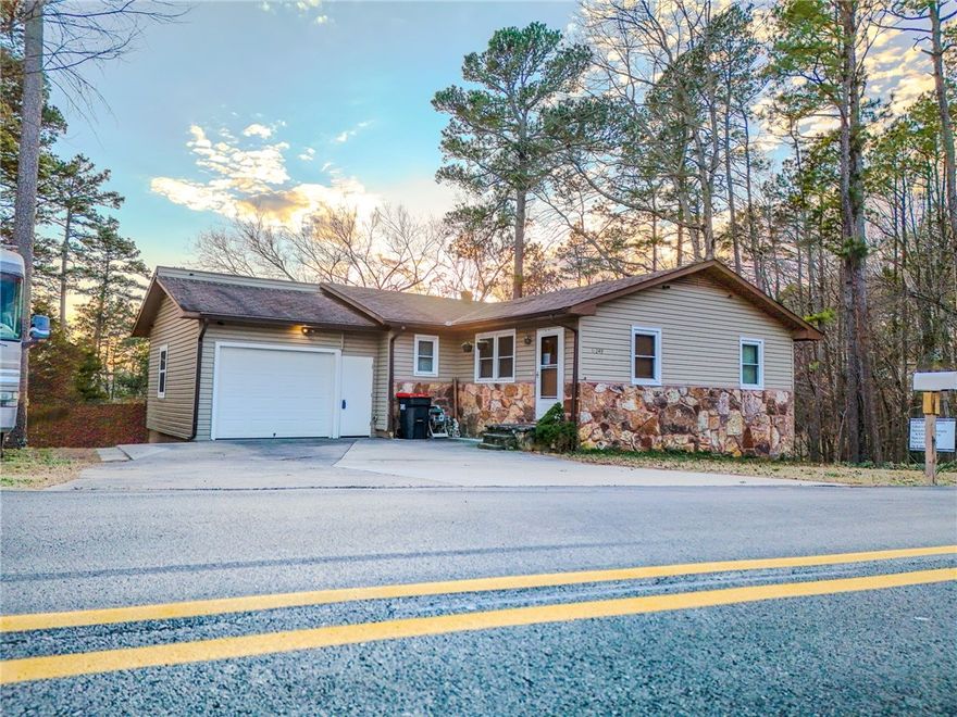 Welcome to 16249 Hickory Dr, nestled among the pines just a short walk to the shoreline and a public boat launch. This well-maintained 5-bedroom, 3-bath home offers 2,208 square feet of living space on a low-maintenance 0.22-acre lot with wooded views and a peaceful back deck. The fully finished walk-out basement features fresh paint, updated flooring, and an improved bathroom, creating ideal space for a home office, guest suite, or hobby area. He shed/she shed and workshop provide extra storage or project space. Inside, you'll find newer carpet in the living room (2023) and updated marble countertops in the kitchen. The layout works beautifully for large households or those needing separate zones for work, play, or hosting. Located in a quiet lakeside area of Rogers with garage parking and no HOA, this property offers excellent potential for full-time living, vacation use, or as a short-term rental investment. Motivated seller.