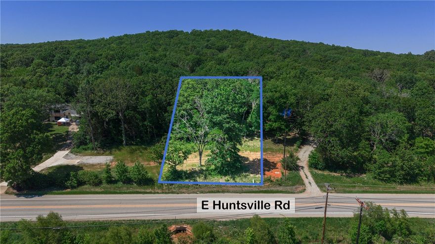 Tucked along highly traveled Huntsville Road with excellent road frontage, this 0.78-acre wooded lot is a rare opportunity to build in one of Fayetteville's most accessible corridors. With mostly wooded coverage and a gently sloping, south-facing terrain, the natural setting provides both privacy and charm. Public water, sewer, electric, and gas are all available at the street, making development refreshingly straightforward. Zoned residential with no flood zone concerns and no covenants, you'll have the flexibility to bring your vision to life. Best of all, you're just minutes from the University of Arkansas campus and the vibrant shops, dining, and entertainment of downtown Fayetteville. Whether you're building your dream home or looking for a smart investment in a booming market, this lot checks all the boxes. Come take a look — opportunity like this doesn't last long in NW Arkansas!