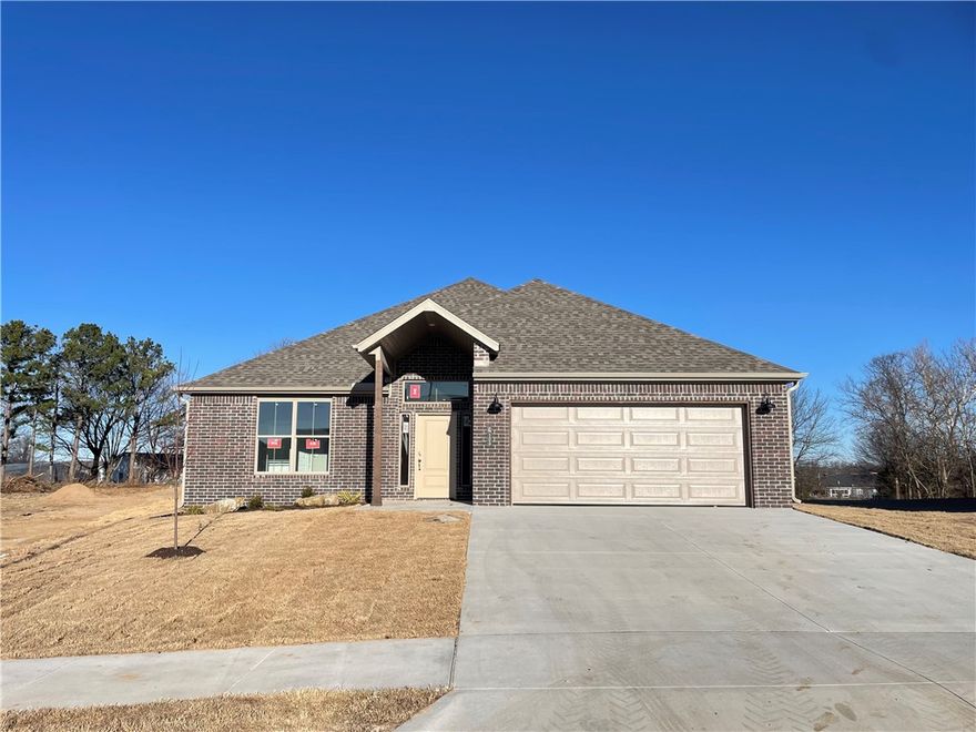 Beautiful one level new construction in Heritage Ranch Subdivision. Located on a large exterior corner lot, enjoy an amazing, upgraded yard space! This home boasts high end features throughout including Luxury Vinyl Plank flooring, Designer Finish Selections, and Quartz Counters to name a few. The bright entry welcomes you in with access to three large guest bedrooms and a guest bathroom. The living space is spacious and open, great for everyday and for entertaining guests. The large eat-in kitchen has plenty of natural light, counter bar seating, and a huge pantry space. The living room boasts large windows overlooking your private backyard, along with a gorgeous fireplace with built in shelving feature. Ample dining space offers more living layout options. The primary suite is a private retreat with luxurious attached bath including a soaking tub, double vanity, large shower, and WIC that connects to laundry. Located close to Schools and Parks with easy access to Downtown Siloam