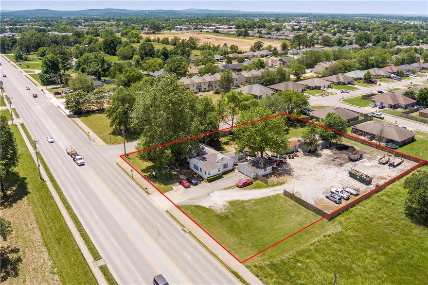 Great investment property or commercial office space. Located on a corner lot of a highly visible
road. Property is 1.14 acres and is zoned C2 with conditional use for residential tenants. RMF4 zoning backs up to the west of the property for potential future development. The house is in great shape, its 2008 sq. ft. with 4 beds/2 baths, full kitchen, laundry room and has been rented out for the past 3 years. It has a detached garage, a large pole barn and another shed that locks for storage. It has an oversized lot that is plenty room for parking, equipment or future expansion, 6ft privacy fence surrounds the entire property with a gate to lock it.  High visibility opportunity on one of the most traveled roads in the Springdale area! With C2 zoning and excellent frontage exposure, this property is ideal for retail, office, or service -based businesses looking to maximize visibility and accessibility. Don't miss your chance to own a highly visible property with incredible business potential! Property is agent owned