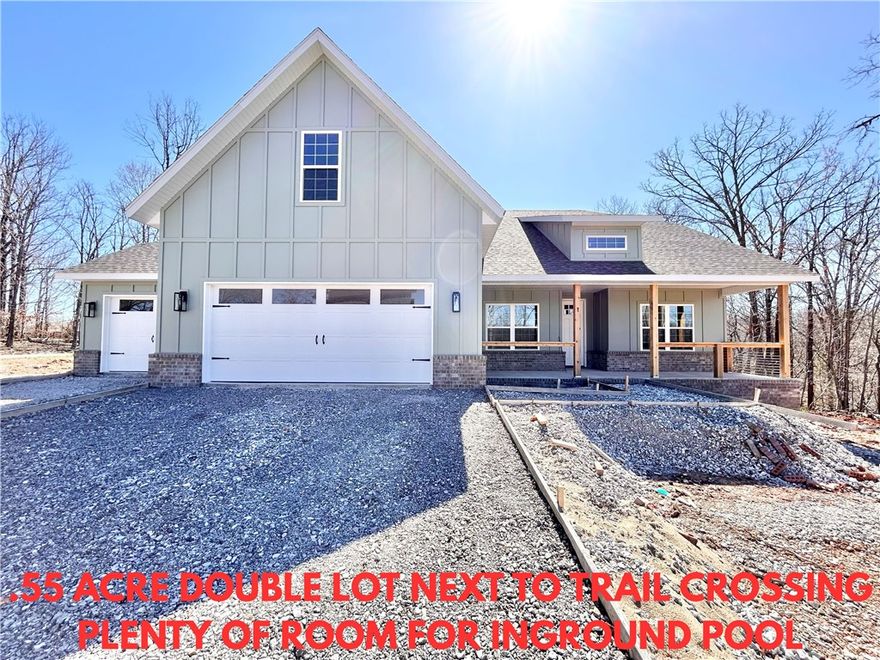 New construction on a .55 acre double wooded lot! Plenty of room for an in-ground pool! Located next to the Tunnel Vision Trail Crossing and just minutes to OZ Bike Lift, Lake Windsor, and I-49. Less than 15 minutes to downtown Bentonville! WOOD FLOORS LOCATED IN ALL BEDROOMS, BONUS ROOM, AND STAIRCASE! Additional features include a spacious 3-car garage, 3 bedrooms + upstairs bonus room with full bath. The kitchen is equipped with a large island, 3 cm quartz counters, custom cabinets,  and a gas range. The living room boasts a beautiful fireplace, exposed beams, and a stunning cathedral ceiling. The primary bath features a luxurious soaking tub, separate vanities, and a huge walk-in closet with a custom tile shower. Custom finishes throughout. Bentonville schools. $3,500 in closing costs when using the builder's preferred local lender.