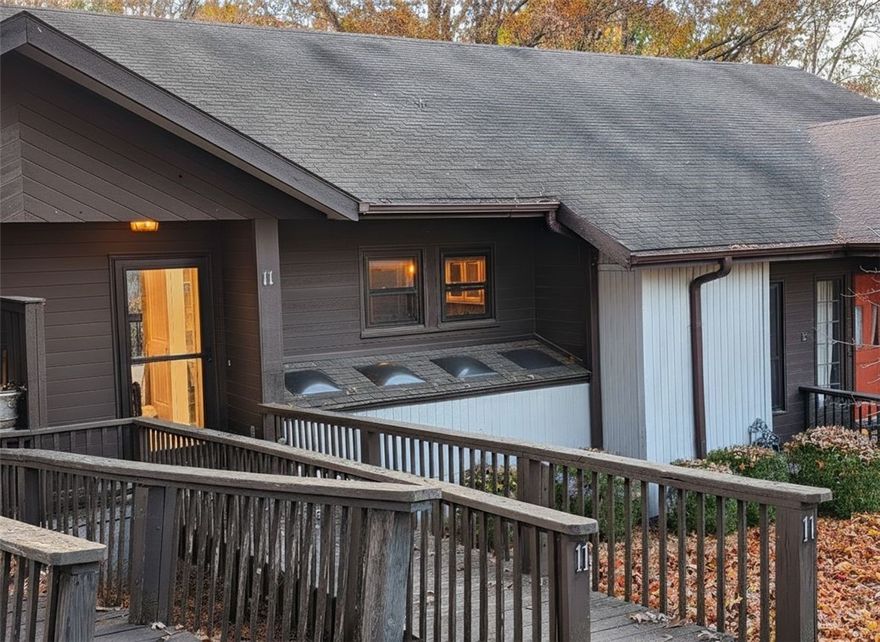 Lake side living on Lake Rayburn & enjoy a ride on 'The Back 40' & 'It'll Bluff Out' trails right outside your front doorstep. Maintenance-free living in this 2 Bed, 1.5 Bath home offering a spacious living area w/private wooded views from 2 outdoor spaces! Home offers brand-new carpet in bedrooms, easy-maintenance wood laminant flooring, an electric log fireplace, & more! Foyer entry opens to the living & dining space with w/access to the half bath. Large sliding doors & windows provide natural lighting & beautiful views. The living room has plenty of space for lounging & entertaining guests. The kitchen offers a gunite sink with abundant counter & cabinet space. Downstairs you'll have the laundry along w/guest bedroom w/ a large closet & connecting bath w/ storage space & large vanity. The primary bedroom is spacious w/access to a large covered deck. Community amenities include golf, fitness, pools, parks, playgrounds, & more! A perfect home or a great addition to your investment​​‌​​​​‌​‌​​​‌‌​​​‌‌‌​​‌​​‌‌​​​​ portfolio.