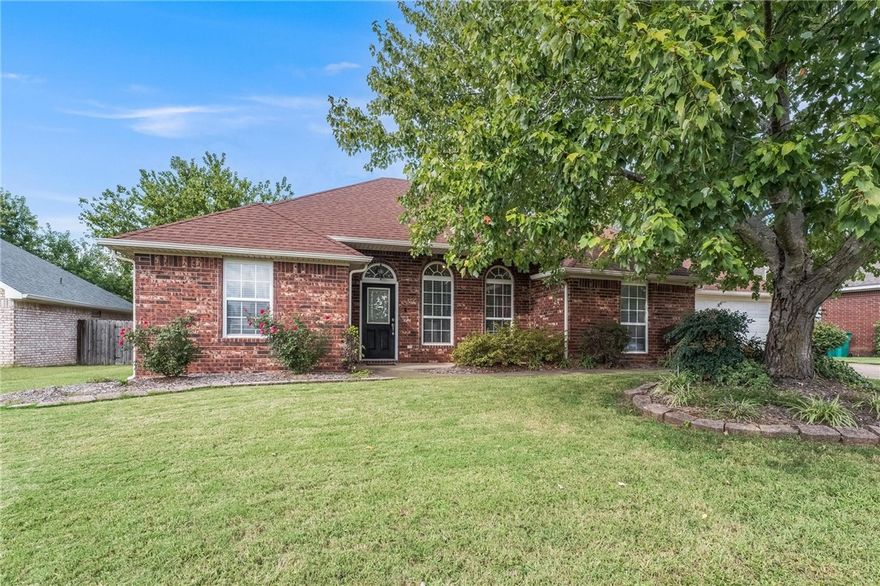 Nestled in the desirable Whispering Timbers Subdivision, this home offers a prime location just minutes from all that Rogers and Bentonville have to offer. Tucked away on a quiet, non-through street, the property backs up to peaceful wooded land, providing privacy and a serene backdrop.  The covered back porch and tranquil backyard create an ideal setting for relaxing or entertaining. Just a short walk down the street, you'll find Cambridge Park with direct access to the extensive trail system—perfect for outdoor enthusiasts.  Inside, the home features hardwood floors throughout, a fully renovated primary bathroom completed in 2023, and tasteful updates to the secondary bathroom. Located directly across from the sought-after Regan Elementary and with quick access to I-49, the location couldn’t be more convenient.  Enjoy being just 10 minutes from the new Walmart Home Office, Pinnacle Hills Promenade, and the vibrant Pinnacle area. A perfect blend of comfort, location, and lifestyle!