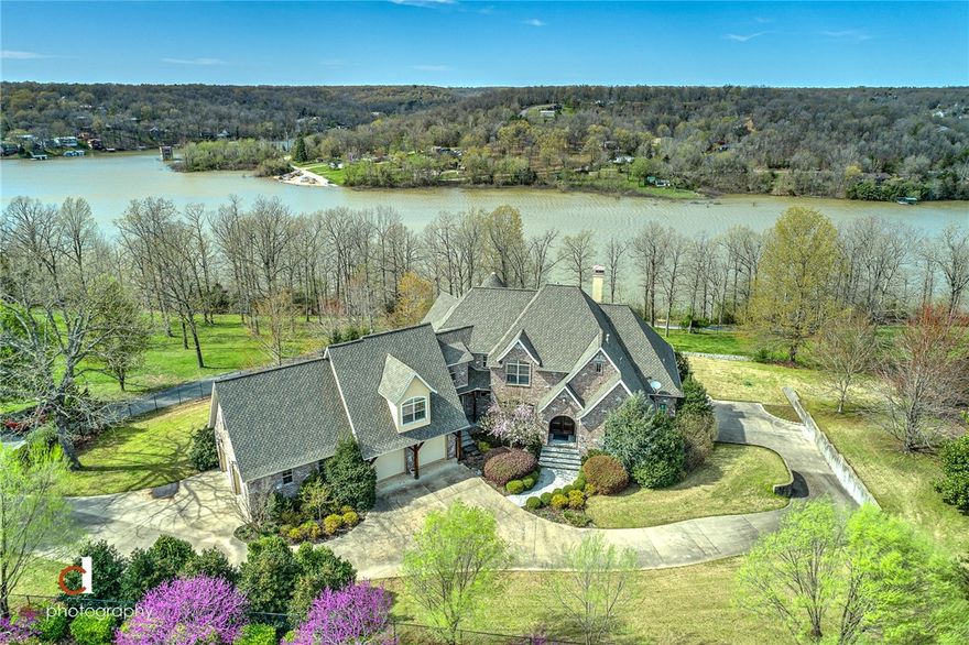 Gorgeous Custom Estate home on Beaver Lake!  This home is exquisite with attention to every detail; the wood trim and molding are amazing throughout; the layout is perfect for gathering family or entertaining guests! Every Bedroom has a private bath. Perfect location - less than 20 minutes to I49 Lowell or Pleasant Crossing Exits (all on paved roads). Entertain, relax, unwind and enjoy the tranquility of the lake and 2.91 acres.  Swim, hot tub, enjoy the sunroom or a bottle of wine from the wine cellar. This home has the character and style you have been looking for!  Don't pass this up!