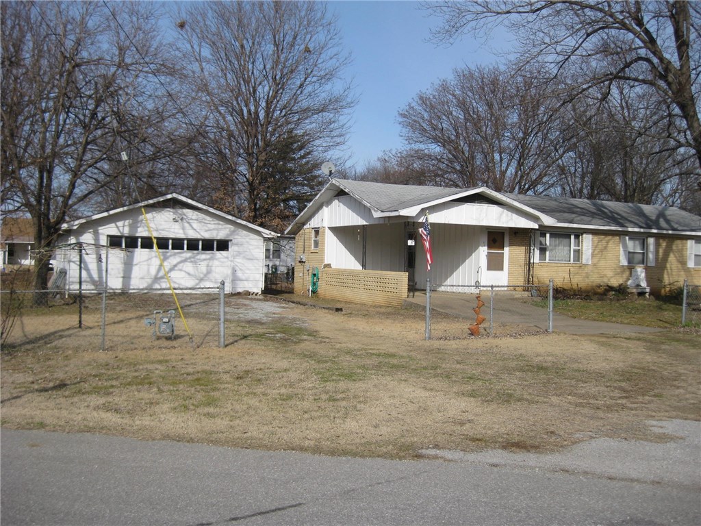 Neat 3 bedroom, 1-1/2 bath brick home on 2 parcels, fully fenced and totaling .43 acre convenient to Hwy 62, schools, U of A, WalMart and everywhere else. Established neighborhood, mature trees, and peaceful setting. Home has an extended utility room plus capability of two full baths. Great detached 2-car 775 SF garage and workshop plus a 1-car carport. Original wood floors in most of the home. Paneled walls throughout - durable and no painting! Come see this one!