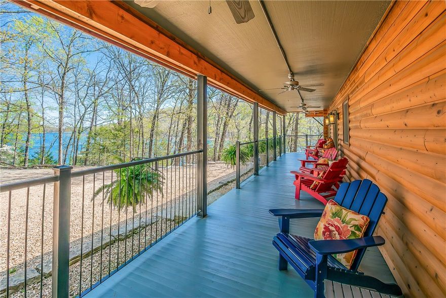 Tucked away down a gated driveway, this 1.57-acre estate rests on picturesque shores of Beaver Lake w/exceptional waterfront access, featuring a sandy beach adjacent to Starkey Marina. This charming fully furnished log home is wrapped in an expansive covered porch, deck w/hot tub, fire pit & scenic cave. Light & airy atmosphere, w/white beadboard walls & large windows framing lake & wooded views. The open floor plan effortlessly connects living, dining, & kitchen areas to the wrap around screened in porch, creating a seamless transition between indoor & outdoor spaces. Huge primary suite w/cozy Fireplace sitting area, en-suite bath, & private access to screened-in porch. The upstairs houses a reading loft/bonus room & 2 additional spacious guest en-suites, each w/their own private bath & walk-in closets. Great unfinished basement area w/sink. With its breathtaking views, exceptional amenities, & prime waterfront location, this property offers the idyllic lakeside lifestyle.