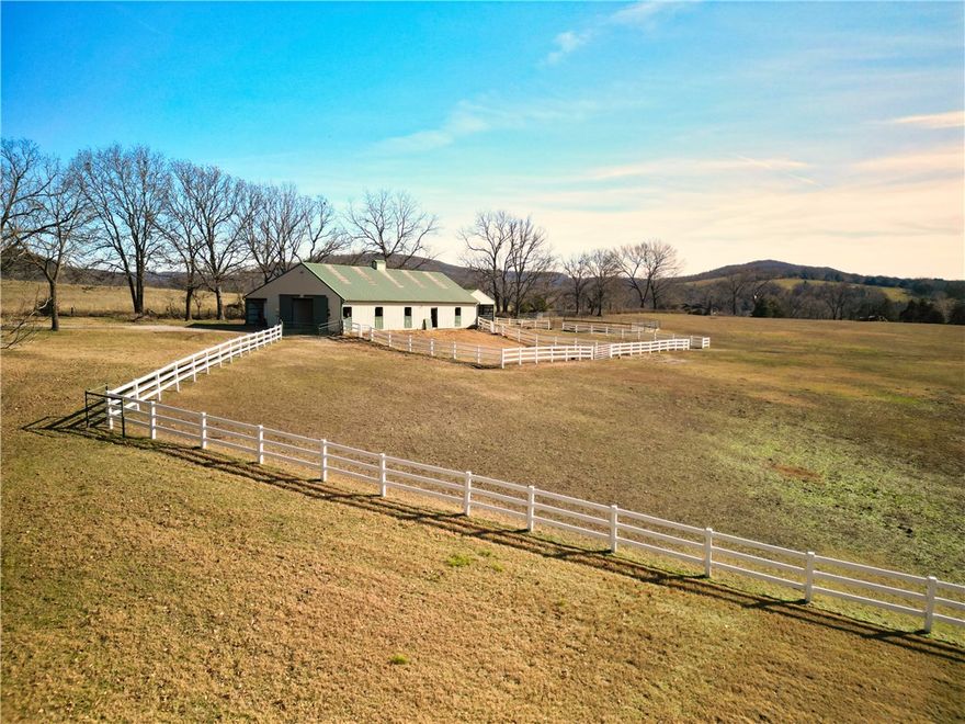 Priced under appraised value! Charming home on 20 Acres in tranquil Drakes Creek Valley. This property features a 1-acre stocked pond w/ catfish, bass bream, and crappie (electric nearby). It has a 48x60 barn fully equipped w/ water, electric, six stalls, an insulated tack room, wash area, trailer storage, hay and shaving storage, and RV outlet. Additionally, there is a 1,121 sq. ft. cozy yurt with a full kitchen, living room, main suite w/ stunning walk in shower, and sleeping loft that that is currently operating as an Airbnb. The primary home boasts gorgeous windows overlooking the property, built-ins, a stone wood burning fireplace, a library in the primary suite, and living area loft. You will also find an adorable chicken coop, a 30x10 run in shelter with tack room, a storage shed, & an equipment shed on the property as well as gorgeous white vinyl fencing. This property is a one-of-a-kind, must see opportunity! Also listed as ML: 1334364. Co-Listing Agent Tony Chrisco Whitetail Properties