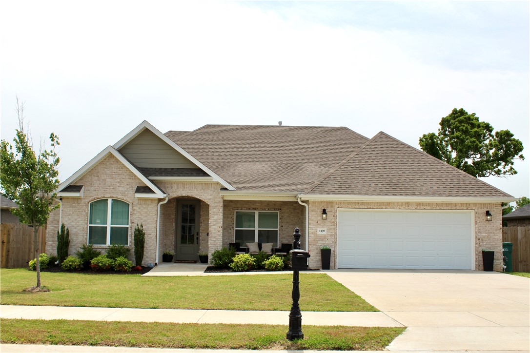 Step into this thoughtfully cared for home nestled in the heart of Tontitown. Built in 2022, this home features a split floor plan with an open concept kitchen and living area. With four bedrooms and two full size bathrooms, this single story home creates a naturally spacious atmosphere. Master suite is found on the west side of the home featuring a walk-in closet, shower, and a whirlpool style tub. Kitchen and living areas feature tile and hardwood floors, upgraded light fixtures, granite countertops, and windows on both sides of the home for plenty of natural light. 1139 Giulia sits only a short walk to the gated community pool and features a fenced in backyard for ultimate outdoor enjoyment.