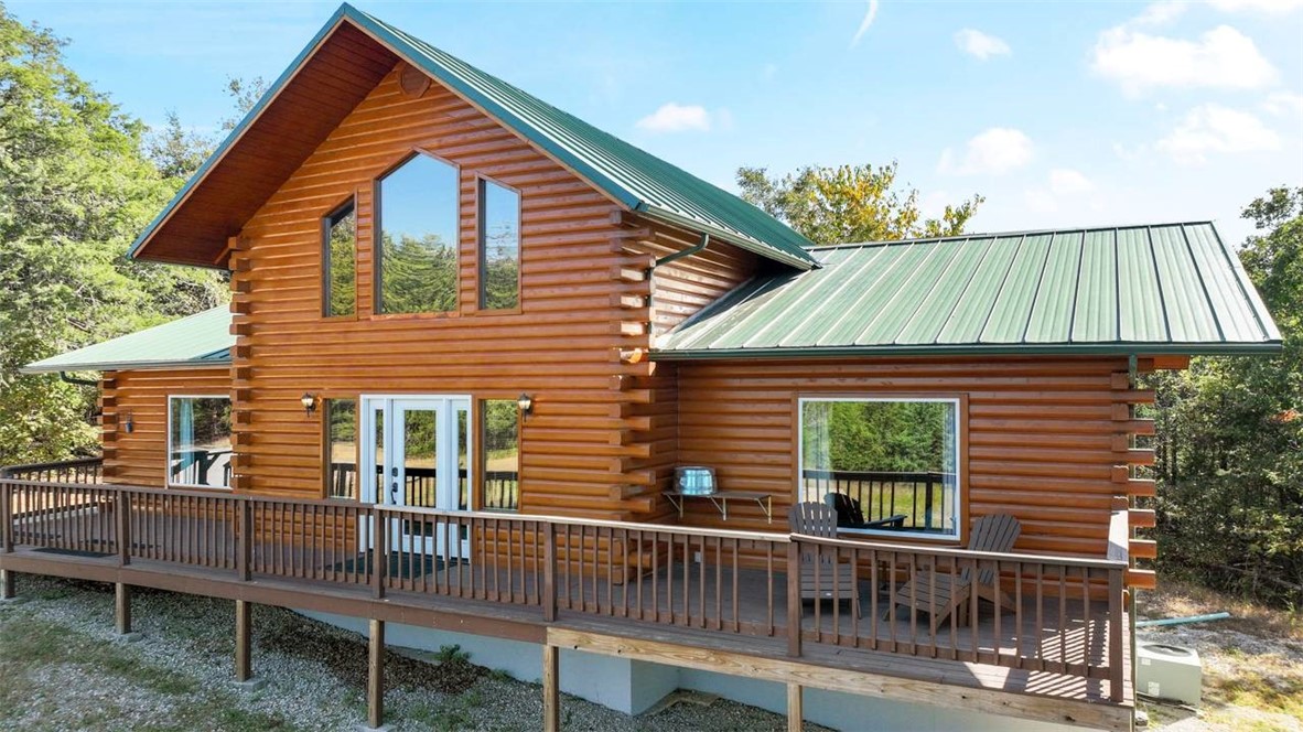 Nestled high atop the majestic Ozark Mountains, this extraordinary "TRUE" log-cabin offers the perfect retreat for those seeking the combination of peaceful tranquility, privacy & natural beauty. With a gated entrance & sprawling 10+ acres, this property is the definition of seclusion, serving as a serene haven for those who appreciate nature's splendor. Currently serving as a well-established Airbnb with rave reviews & high occupancy rates, add it to your portfolio or make it your primary/second home! Exterior Cabin has been sealed for longevity & maintenance protection. Situated conveniently close to several iconic destinations, this well-maintained log cabin makes for an ideal retreat for Eureka Springs, Holiday Island, both the White & Kings River, and Table Rock Lake. Whether you seek a tranquil retreat or a savvy investment, this mountain-top log cabin offers the best of both worlds. Propane tank is full and ready to go for winter. All furnishings, furniture, & appliances convey.