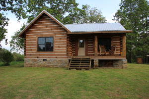 Genuine log home on 193 acres. Home features covered porch, lo walls for energy efficiency, stainless appliances, granite countertops andcustom cabinets. Vaulted ceiling and wood stove in loving room. Property has HUGE spring and caves, mature hardwoods, along with fruit treesand wild berries. Plenty of deer, turkey, bear and hogs for hunting. Trails run throughout property. Only minutes to Buffalo National River.
