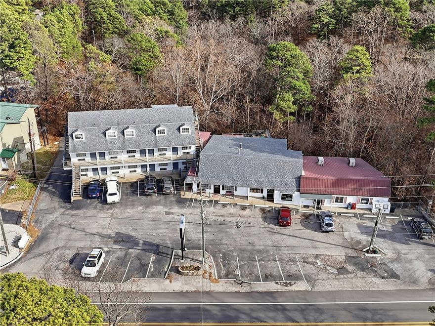 Introducing Alpine Liquor & Lodge, a rare opportunity to acquire two established, highly profitable businesses in the thriving tourist destination of Eureka Springs. Located on ±2.8 acres just off Hwy 62/E Van Buren with approx. 7,000 VPD, this high-visibility property offers excellent access and exposure. The income-producing property includes a successful liquor store—one of only three in town—and a well-maintained 22-room lodge, both with strong operating history. The store features large walk-in coolers, three new mini splits, and a generator system. The lodge offers 9 long-term rental units and 12 nightly rentals, creating stable, diversified revenue. A spacious lobby and ±1,472 SF top-level manager’s quarters. The sale includes furniture, fixtures, and equipment, inventory available separately. Also included are 32 parking spaces and ±1.13 acres of unused land. With no new liquor licenses available in Carroll County, this is a strategic investment opportunity in one of Arkansas’s premier tourism markets.