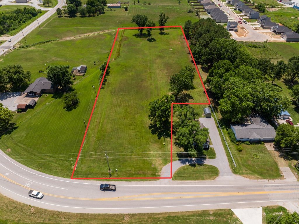 Excellent investment opportunity. 3.2 acres of flat, buildable land in the heart of Gentry AR. Owner has initial drawings showing space for 13 buildable lots. R2 zoning allows for duplexes or single family. Convenient location close to everything in Gentry and a short drive to Bentonville. The home is also available on an additional .37 acres.