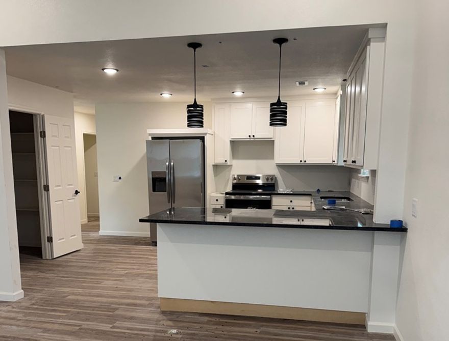 This home combines space, style, and location, ideal for families or professionals seeking comfort and accessibility. Welcome to a beautifully renovated 4-bedroom, 2.5 bathroom home with ample parking, located in the desirable Rogers area close to downtown.  2 of the bedrooms share a large, jack and jill bathroom. Just minutes from I-49, this property offers both convenience and comfort in a prime location close to shopping, dining, hospitals, and more. The home offers split bedroom layout, ideal for guests or home office. Eat-in kitchen with large walk in pantry, and stainless appliances. Brand new countertops and backsplash throughout the kitchen and baths.  Newly installed flooring, light fixtures, fans, washer and dryer, fridge, paint.. Every single thing about this home has been redone, including new windows and blinds! Don’t miss out on this newly redone home close to everything Rogers!