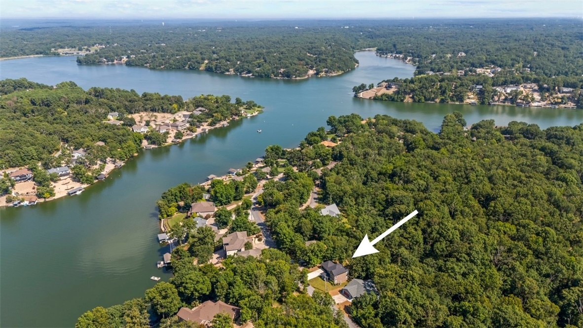 Come see this light-filled home, across the street from lakefront homes on Loch Lomond. Enjoy seasonal views of the lake. The property is beautifully landscaped front and back, with a custom stonework patio in back and a pretty hardscape path. Inside downstairs is a well designed entry, a half bath, a large inviting living room with three windows, a cheery large dining area surrounded by windows, with a modern vibe kitchen. One full side of the kitchen is glass looking onto the back deck and pretty lawn flanked by tall trees. The kitchen boasts quality appliances, granite counters, and beautiful light fixtures. Upstairs is a large primary bedroom, spacious primary bathroom with garden tub, shower, and dual vanity. Also upstairs, a guest bedroom, a bonus/office, a full bathroom, and a laundry space. House is five min. to two public access boat docks - one is lovely Tiree Park, 5 min. to full service Branchwood Rec Center, 15 min. to Lakepoint Marina - rent boats, and 15 min to world renowned bike trails!