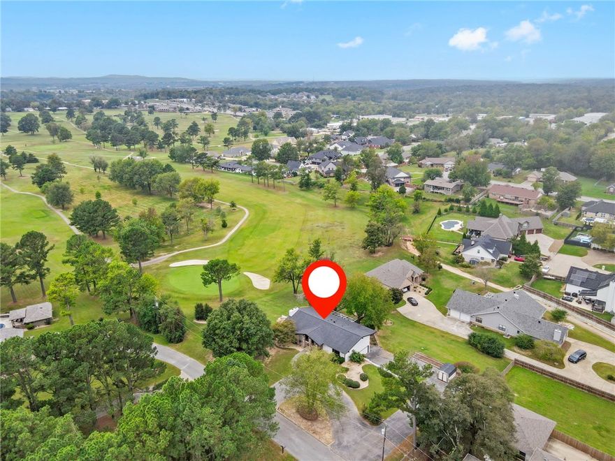 A golfer's dream on the 6th green! Enjoy expansive views of the Springdale Country Club golf course from the two decks of this completely remodeled home. This beautiful home was redesigned for entertaining with an open floor plan, vaulted ceiling, floor-to-ceiling rock fireplace, and gourmet kitchen. An all-weather sunroom adjacent to the kitchen, a spacious primary bedroom and ensuite bath with huge tiled shower and dual-sink vanity, and a second bedroom and bath complete the main level. A lower level apartment with 1 BR/1 BA, living room, kitchenette, 2nd BR/ office/walk-in closet, separate ground-floor access, and patio has endless possibilities (multi-generational living, rental, home office, man cave, etc.). Oversized 2-car garage. Plus, a 300 sf workshop! Top/down remodel: new plumbing, electrical, flooring, windows, doors, and a new roof (2025). Great location on a private drive with only two homes, near shopping and restaurants, Lake Fayetteville,10-15 minutes to Tyson HQ and I49.