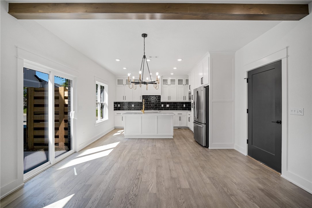 Stunning new construction home in downtown Bentonville. Hard to find new construction this close to all the action of the biking trails, farmers market, Crystal Bridges, Compton Gardens, Bentonville Square, restaurants, shopping and entertainment. WOW! Great open plan with great space for entertaining and a SWEET primary SUITE upstairs with a resort style bathroom. Gorgeous wood flooring throughout the entire main floor, plus the stairs and landing/hall upstairs and in the Primary suite. Custom cabinets, GE profile appliance package (including matching refrigerator), quartz counters throughout. Surround sound, electric linear fireplace, electric car charging in the attached 2 car garage. Modern window shades plus full privacy fence for side yard. The neighborhood includes community green space with pavilion, guest parking and nice wide sidewalk. Just move in and enjoy the downtown lifestyle!