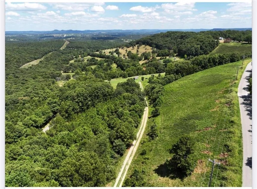 Are you looking for one of the most gorgeous views in Eureka Springs....or maybe even NWA? We have it for you with this 5.7 acres +/- of land with endless opportunities. The absolute best place to build your dream home, wedding event center, family compound or mini subdivision. This land is prime full of wildlife and the sunrises and sunsets are something that you will write home to Grandma about as they just can't be beat! You are literally only a 10 minute drive to downtown Eureka Springs, so with the stunning views you also get an exceptional location. The property has an electric service pole, water well and septic tank on site. Don't let me forget to tell you about the existing 36 x 36 foot metal red barn on the property that is in great shape and an excellent place to store things while building or maybe make a hunting style barndaminium. As stated the opportunities are endless with this land, so bring your imagination and lets make dreams happen!