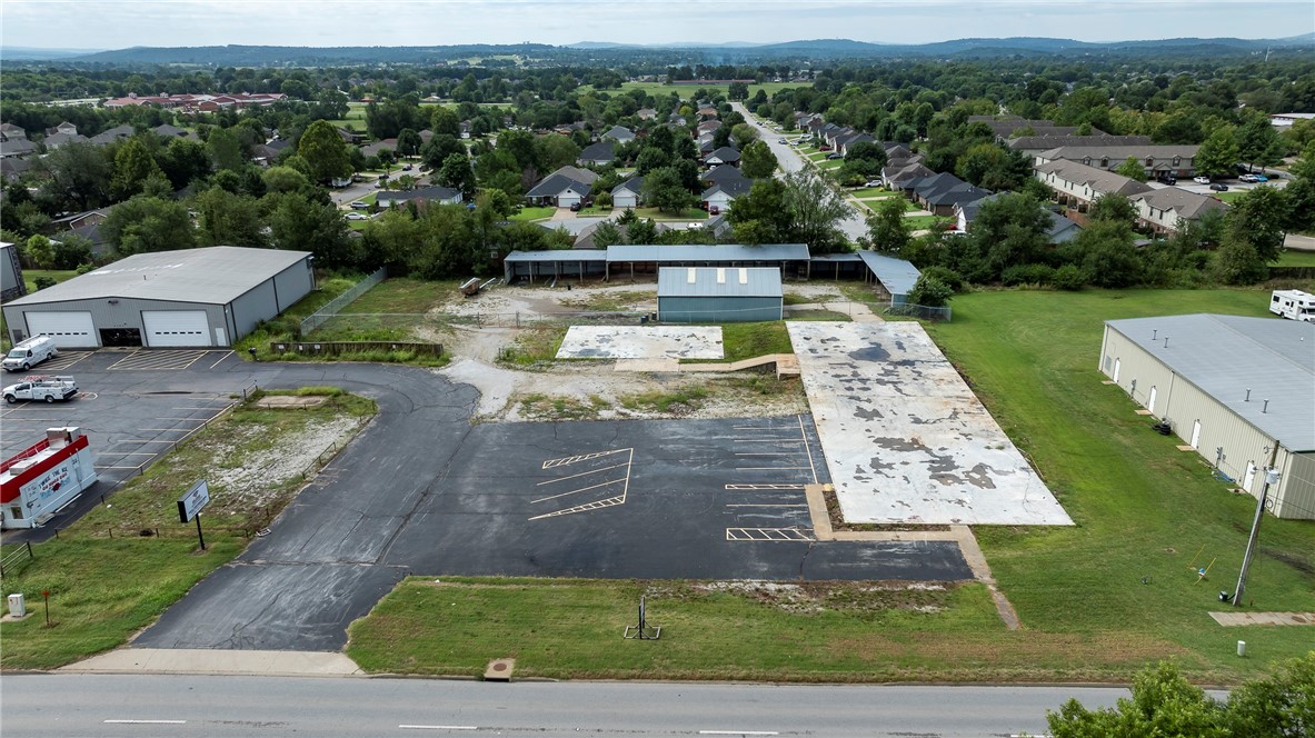 Discover the perfect commercial opportunity with this versatile property offering a unique blend of features designed to accommodate a wide range of business opportunities right on hwy 412 E! The lot provides ample room to expand, with the potential to add more warehouse space or to develop retail space, a flex warehouse, or a combination of both, this property offers an open slate to bring your vision to life. Situated on 1.80 +/- acres, this property has a 2,000 sqft warehouse space, perfect for storage or distribution. Additionally, the property includes covered outdoor storage, ideal for equipment or inventory that requires protection from the elements. The site is fenced, Tenant or owner is to provide their own security measures. The property where the fence is enclosing the warehouse portion is also for rent, $3,000.00 a month. Every Tenant is Responsible contacting the City to verify their specific use for the property.