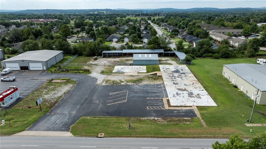 Discover the perfect commercial opportunity with this versatile property offering a unique blend of features designed to accommodate a wide range of business opportunities right on hwy 412 E! The lot provides ample room to expand, with the potential to add more warehouse space or to develop retail space, a flex warehouse, or a combination of both, this property offers an open slate to bring your vision to life.  Situated on 1.80 +/- acres, this property has a 2,000 sqft warehouse space, perfect for storage or distribution. Additionally, the property includes covered outdoor storage, ideal for equipment or inventory that requires protection from the elements. The site is fenced, Tenant or owner is to provide their own security measures.  The property where the fence is enclosing the warehouse portion is also for rent, $3,000.00 a month. Every Tenant is Responsible contacting the City to verify their specific use for the property.