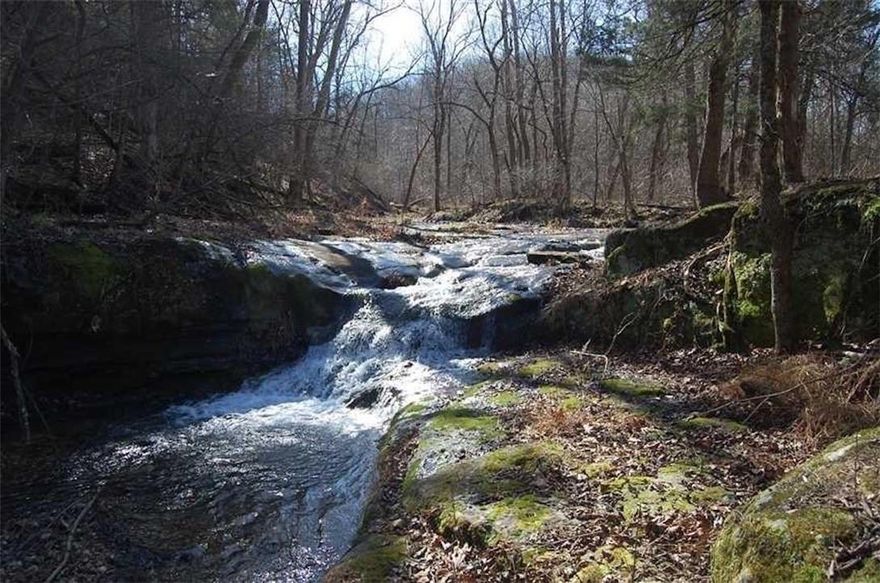 142.88 acres of premier recreational land in Madison County, Arkansas, just outside of Clifty. This property features an established trail system throughout, making it easy to access by ATV or vehicle. Two spring-fed creeks run through the property and converge to create a stunning natural waterfall—one of the most unique features you’ll find in the area.
This tract represents the headwaters of Big Clifty Creek, eventually feeding into Beaver Lake, adding long-term natural value and appeal. The land offers a great mix of terrain, privacy, and usable ground ideal for hunting, recreation, or building a secluded cabin retreat.
Conveniently located just 22 miles to Rogers, 35 miles to Fayetteville, and 15 miles to Eureka Springs, offering the perfect balance of seclusion and accessibility.
Rare opportunity to own a large acreage tract with water features, trail access, and proximity to Northwest Arkansas amenities.