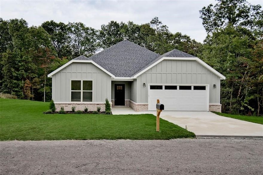 New construction on a large .36 acre wooded lot located near the Back 40 Trails, Lake Brittany, and Metfield Golf Course! Bentonville schools! Step inside to discover an inviting open concept design featuring 10' ceilings and beautiful floors that enhance the spacious feel of the home. The stylish kitchen is equipped with a gas range, 3 cm quartz countertops, custom cabinets, and a walk-in pantry. Entertain or unwind in the living area, complete with a stunning fireplace, or step out onto the covered patio to enjoy the peaceful surroundings. The primary suite features a massive walk-in tile shower and closet. 2 bedrooms + office. High-end finishes throughout.