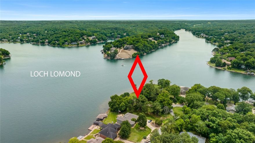 1.18 acres of the best Loch Lomond view is now available. The flat double lot located at the intersection of 3 branches of the lake allow you panoramic views from your beautifully landscaped back yard. Established trees and carefully landscaped beds offer a park like setting. Walk down to the water and relax on the built in benches, soak up the sun on the swim deck or launch your boat from the boat dock. This one level home with walkout basement has 3 bedrooms and 2 baths on the main level. Wall to wall windows grace the back of the home. Spend evenings on the open deck or large screened in porch. The walkout basement has a large bonus room with wood stove, sink and mini fridge, a full bath, an office looking out on the lake, and you will have plenty of room for projects in the 17X18 heat/cooled workshop. This home is ready for your personal touches. 257' of shoreline MOL. The roof is 2019 and the home has been recently appraised. New septic 2010 * Video-https://vimeo.com/828206752