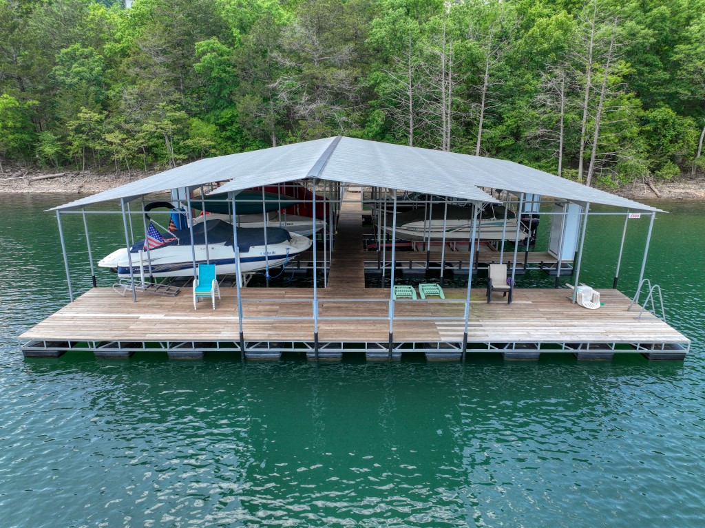 Brand new, never lived-in, lake front, REAL log home home with a 26ā community dock slip! Construction of this amazing getaway has just been completed and is now available. Come experience the new house smell without any of the decisions or waiting! Located barely off of a paved road, near Beaver Dam and Starkey Marina, this house is move in ready. In addition to the huge amount of driveway parking, the oversized carport can fit up to four cars. The covered porch and lower patio are great hangout spots away from the sun and rain. The crisp interior has the perfect blend of colors and textures to break up the look of the wood logs and beams. Each level has a full bathroom and bedroom, with the loft having two bedrooms. This log home is within walking distance of the dock slip and a concrete boat ramp for easy access to Beaver Lake!