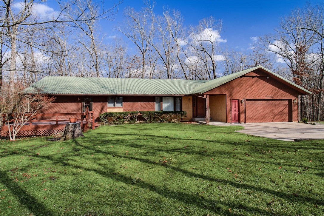Find peace and tranquility just 6 minutes from downtown Rogers and 5 miles from Beaver Lake! This immaculately kept home is tucked away on a 2.24MOL acre lot filled with hardwoods, 1000's of bulbs, beautiful landscaping and lots of birds & wildlife. A 3 minute drive brings you to Lake Atalanta, which includes walking & biking trails, fishing, a playground/picnic area and a dog park. Gorgeous forest views from 2 large decks, an immense, vaulted living/dining combination great room with a stone fireplace wall and split floor plan bedroom suites make this home a special space. Storage is abundant. Each room is comfortably large and the layout just simply works! - Make an appointment to see this treasure!