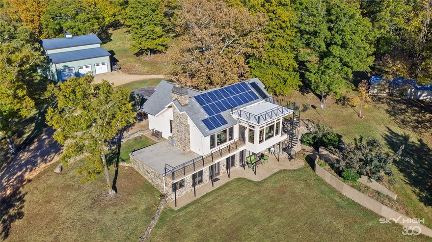 Experience a lifestyle of sustainability & effortless living in the Ozark Mountains. Highlighted by scenic trails & creek, private lake & cascading waterfall this 220 acre estate is unmatched. Energy efficient custom home w/off grid capabilities including: Southern facing 4.9kw roof-mounted solar panels, 3 geothermal wells & solar hot water system. Fieldstone FP. Gourmet kitchen w/SS appliances, soapstone counters & walk-in pantry.Wall windows throughout. Designer finishes. Resort style owner’s suite w/French doors, travertine bath, walk-in shower & jacuzzi tub. Additional en-suites w/access to patio. Safe room w/plumbing. Detached 6 car garage:1600sf w/shop, unfinished 660sf loft. Ideal for the outdoor enthusiast offering hunting, fishing, horseback riding, wildlife habitat & AR fieldstone capturing the beauty of the natural state. Also see Land Listing MLS #1180913