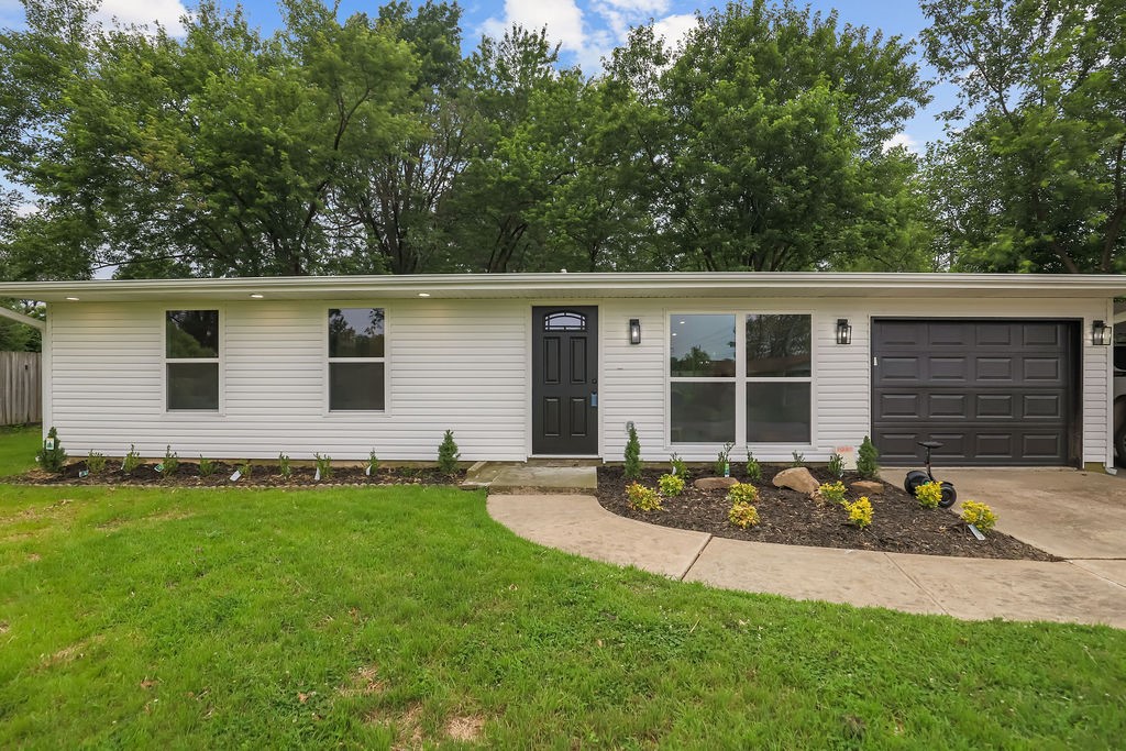 This completely renovated 4-bedroom home at 802 Hinshaw has been expertly rebuilt from the ground up, retaining only three original exterior walls. Every major system is brand new including electrical, plumbing, HVAC with ductwork, water heater, and furnace. The roof was rebuilt and raised one foot for higher ceilings, while half the slab foundation was completely reconstructed. Premium features include new LVP flooring throughout, butcher block countertops, custom cabinetry, LED recessed lighting and chandeliers, plus all new windows, doors, and vinyl siding. The home offers approximately 1,476 square feet with a primary suite featuring dual closets and ensuite bathroom with tiled shower, plus a full guest bathroom with tub. Additional highlights include a covered two-car carport spanning the home's width, one-car garage, utility room, and spacious, fenced backyard with mature trees. This turnkey property combines modern systems with thoughtful design, all at a great price and in a convenient Springdale location.