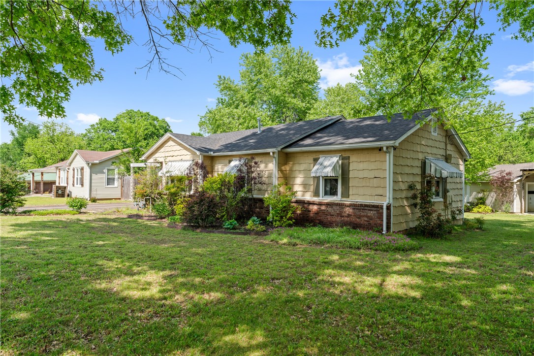 South Fayetteville gem with updates already in place. Original hardwood floors, a wood-burning fireplace, and newer windows showcase the home’s character, while recent upgrades provide peace of mind—new HVAC and ductwork (2024), hot water heater (2023), and roof (2019). Kitchen updates include a new dishwasher (2025) and gas range (2022). Enjoy the landscaped yard with mature trees from the screened-in back porch. This home is minutes from the University of Arkansas, only 1/2 mile from a university bus stop, and steps from the Razorback Greenway. Within walking distance of Baum Stadium, South Yard, local restaurants & breweries. Close to I-49. Great investment opportunity as a rental or flip, with RMF24 zoning in one of Fayetteville's fastest growing neighborhoods. Sold as-is. //Also listed as .13 acre with MLS number 1323605 and .31 acre lot with MLS # 1323606//