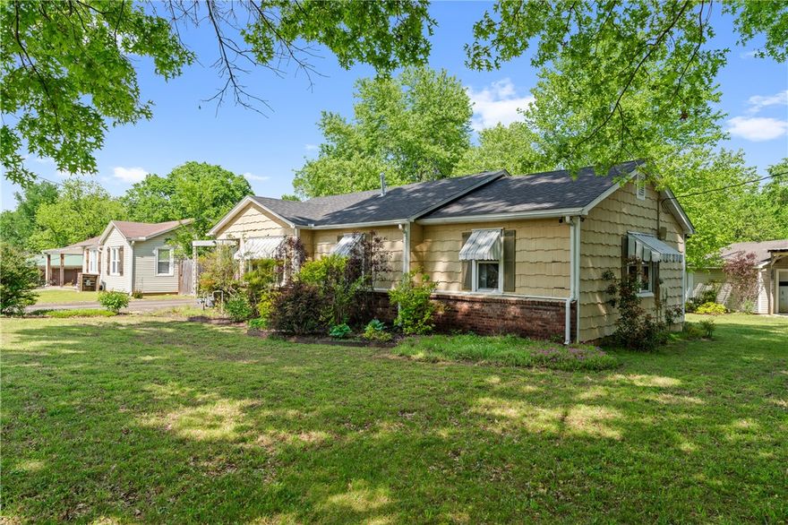 South Fayetteville gem with updates already in place. Original hardwood floors, a wood-burning fireplace, and newer windows showcase the home’s character, while recent upgrades provide peace of mind—new HVAC and ductwork (2024), hot water heater (2023), and roof (2019). Kitchen updates include a new dishwasher (2025) and gas range (2022). Enjoy the landscaped yard with mature trees from the screened-in back porch. This home is minutes from the University of Arkansas, only 1/2 mile from a university bus stop, and steps from the Razorback Greenway. Within walking distance of Baum Stadium, South Yard, local restaurants & breweries. Close to I-49. Great investment opportunity as a rental or flip, with RMF24 zoning in one of Fayetteville's fastest growing neighborhoods. Sold as-is. //Also listed as .13 acre with MLS number 1323605 and .31 acre lot with MLS # 1323606//