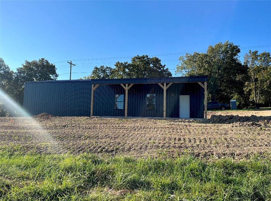 These brand new commercial / warehouse / flex space buildings with MAJOR highway 412 frontage JUST hit the market. Each building is 1800 sq ft. on 1.66 acres with an office, bathroom, and a shop sink in the bay area for convenience. Enjoy this versatile opportunity and build the inside to suit your specific operational needs. This building features 2 12x10 insulated overhead garage doors, facilitating smooth loading and unloading. This property is ideal for business owners seeking expansion or investors looking for a lucrative development opportunity in Northwest Arkansas.