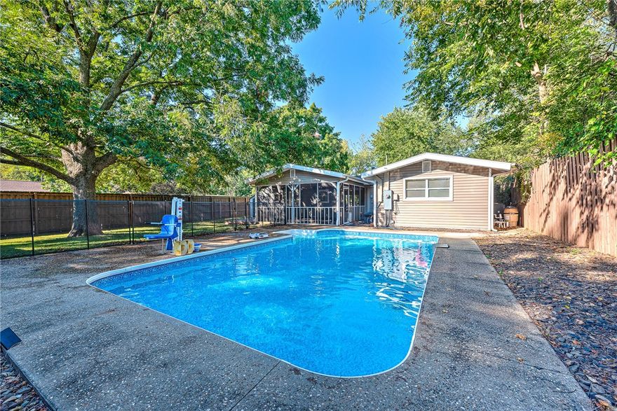HOUSE WITH A SPARKLING IN GROUND POOL AT THIS PRICE? Fall in love with this charming East Fayetteville ranch-style home featuring a sparkling heated inground pool nestled in a shaded backyard oasis. Inside, you’ll find beautiful wood flooring, an updated kitchen that opens to the living and breakfast areas, 3 bedrooms, 2 baths, and a dedicated office—perfect for working from home. Enjoy relaxing on the screened back porch, ideal for watching the backyard fun or sneaking in a peaceful Sunday nap. Vaulted ceilings, mature trees, and an 8-ft privacy fence enhance privacy. Additional highlights include a 3-year-old roof, pool installed in 2012 with a new liner (2022) and robotic cleaner for easy maintenance, plus a portable pool fence that can be removed easily. An 8x10 storage building and storm shelter add convenience and peace of mind. Conveniently located near schools, shopping, restaurants, and the Fayetteville trail system—come see this wonderful home today!