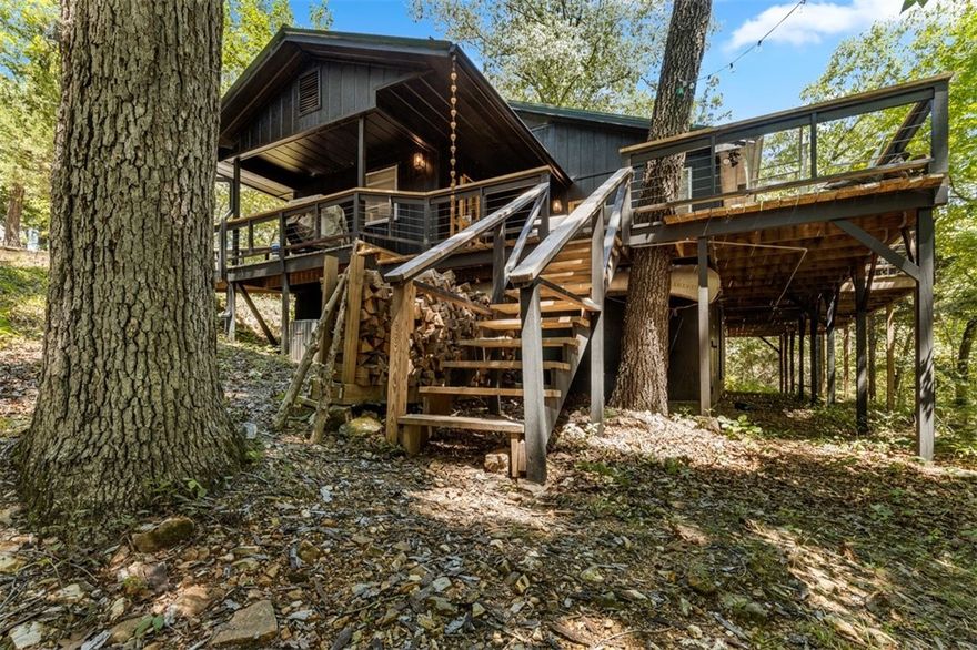 This beautifully renovated 2,202 sq. ft., 3-bed, 2-bath home on 3.6 wooded acres offers stunning views in the Ozarks, near Jasper, AR, and the Buffalo River. Located close to Dogpatch and Johnny Morris' planned Marble Falls Nature Park in Newton County, it features a vaulted living room, finished basement with a game room, three native stone fireplaces, and a concrete-topped safe room. The property has rural and well water, a metal roof, and a large deck. Currently a successful nightly rental, this charming home is perfect for those seeking a serene retreat.