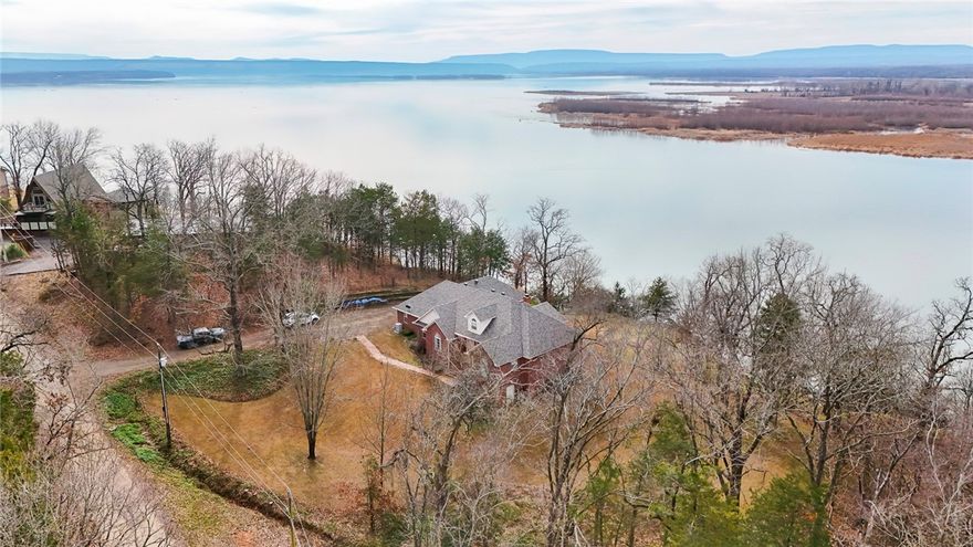 Perched above the Arkansas River and Lake Dardanelle, this home offers a view that never gets old. Sunsets stretch across the water each evening, creating a backdrop you will appreciate from the deck, the living spaces, and your everyday routines.

This 2,328 sq ft home features 3 bedrooms, 2 bathrooms, and a 2-car garage, all designed with comfort and functionality in mind. A split floor plan provides added privacy, giving the primary suite ample space to unwind, along with its own deck exit. Just off the garage is an enclosed room ideal for a hobby space. Above the garage, you will find additional storage with easy walk up access, a rare and practical bonus.

Major updates bring peace of mind, including a new roof installed in March 2025 and an HVAC system that remains under warranty. 

This property combines a sunroom to enjoy the scenic views throughout the year.  If you have been waiting for a place where the view is just as impressive as the home itself, this one deserves your attention.