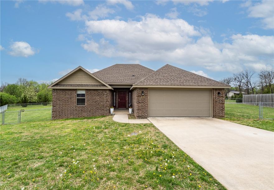 This charming one owner 4 bedroom, 2 bath all brick home is situated on a cul-de-sac backing up to property owned by the city of Gentry. Enjoy the view from the covered patio, watch the birds or walk out the back gate and enjoy the park-like setting behind the whole cul-de-sac area.  Located just minutes from Gentry Public Schools and downtown, it may just be the perfect location for you! The open split floor plan creates private living spaces and makes entertaining a breeze. Granite counters, tile and engineered wood floors enhance the living spaces. The .35 acre yard has chain link fencing around the backyard. The two car garage is attached to the house.