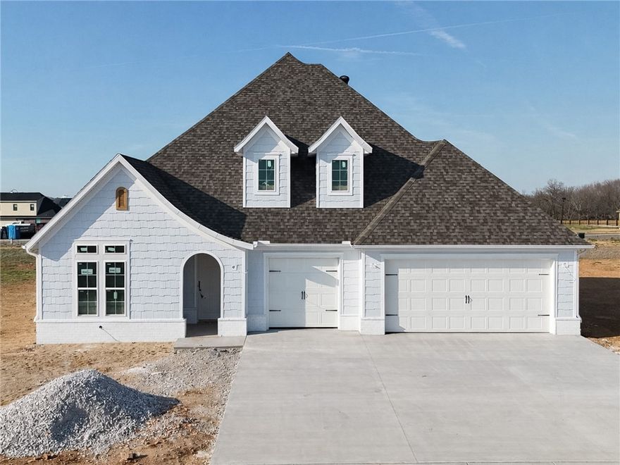 Welcome to County Line Square, a new Springdale community steps from Shaw Family Park with a pool and pavilion for residents. The Ashland plan opens to a foyer with the staircase, along with a guest bedroom or office and a full bathroom to the left. The foyer leads into an open living and dining area with a fireplace as the focal point and engineered wood floors throughout the first floor. The kitchen connects to the living space and includes a large island, quartz countertops, cabinets to the ceiling, GE Profile stainless steel appliances, and a pantry. The main level primary suite features a vaulted ceiling and a bathroom with a double vanity and centered makeup vanity, a walk-in shower, and a large walk-in closet that connects to the laundry room. Upstairs offers 2 bedrooms and a full bathroom. Enjoy the covered back patio and a spacious 3-car garage. A fence, gutters, and blinds are included. Builder’s preferred lender is offering $3500 toward closing costs or a rate buy down. *Agent Owned*