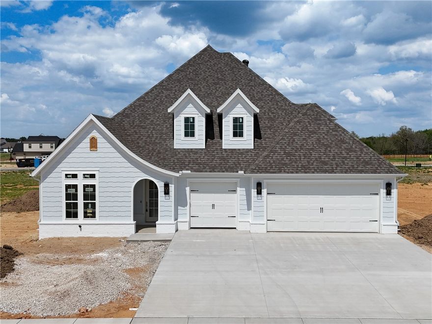 Welcome to County Line Square, a new Springdale community steps from Shaw Family Park with a pool and pavilion for residents. The Ashland plan opens to a foyer with the staircase, along with a guest bedroom or office and a full bathroom to the left. The foyer leads into an open living and dining area with a fireplace as the focal point and engineered wood floors throughout the first floor. The kitchen connects to the living space and includes a large island, quartz countertops, cabinets to the ceiling, GE Profile stainless steel appliances, and a pantry. The main level primary suite features a vaulted ceiling and a bathroom with a double vanity and centered makeup vanity, a walk-in shower, and a large walk-in closet that connects to the laundry room. Upstairs offers 2 bedrooms and a full bathroom. Enjoy the covered back patio and a spacious 3-car garage. A fence, gutters, and blinds are included. Builder’s preferred lender is offering $3500 toward closing costs or a rate buy down. *Agent Owned*