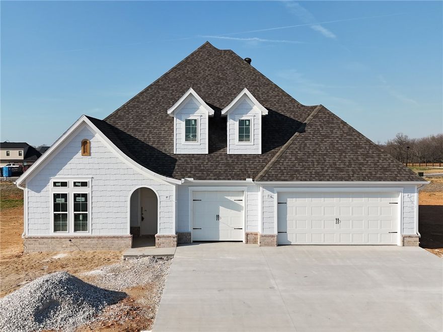 Welcome to County Line Square, a new Springdale community steps from Shaw Family Park with a pool and pavilion for residents. The Ashland plan opens to a foyer with the staircase, along with a guest bedroom or office and a full bathroom to the left. The foyer leads into an open living and dining area with a fireplace as the focal point and engineered wood floors throughout the first floor. The kitchen connects to the living space and includes a large island, quartz countertops, cabinets to the ceiling, GE Profile stainless steel appliances, and a pantry. The main level primary suite features a vaulted ceiling and a bathroom with a double vanity and centered makeup vanity, a walk-in shower, and a large walk-in closet that connects to the laundry room. Upstairs offers 2 bedrooms and a full bathroom. Enjoy the covered back patio and a spacious 3-car garage. A fence, gutters, and blinds are included. Builder’s preferred lender is offering $3500 toward closing costs or a rate buy down. *Agent Owned*