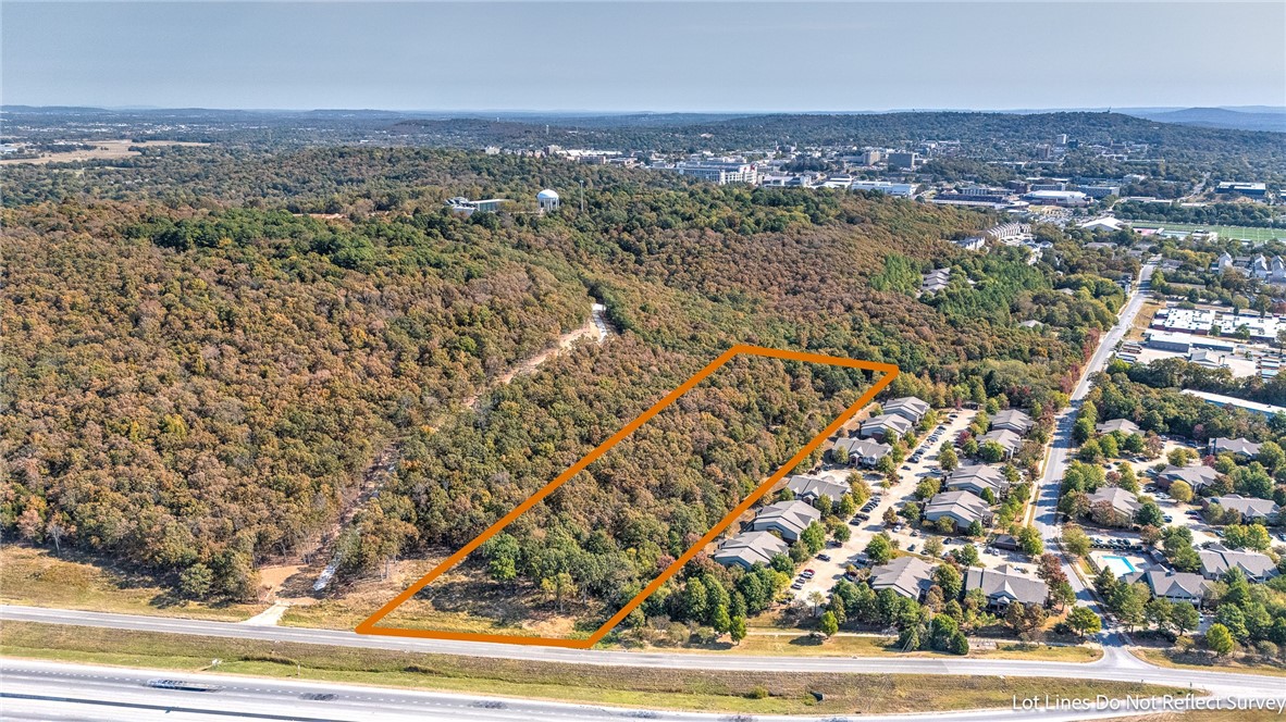 9.14 Acres Just 5 Blocks to the University Of Arkansas Campus. This land is currently zoned RSF-4 but is in a Area where The New Neighborhood Services General Zoning could be possible. The land is wooded and has multi family apartments adjoining to the south and future project Student housing project that is being proposed adjoining to the North.