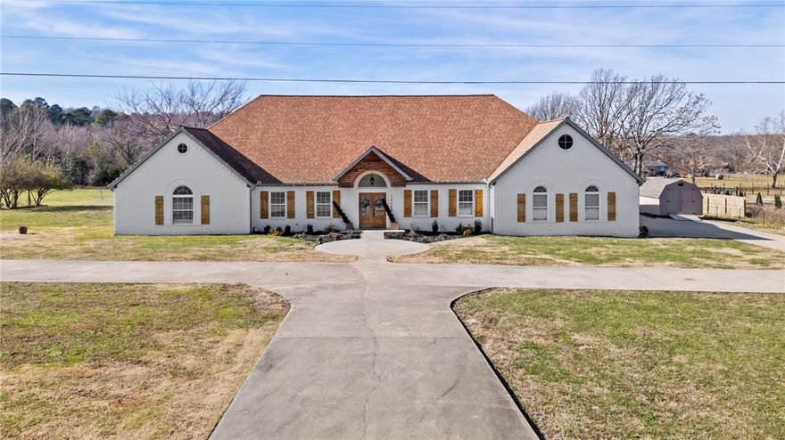 Welcome to 12265 Greasy Valley Road in Prairie Grove, AR! This beautifully updated home offers 6 generously sized bedrooms, including a convenient guest suite on the main floor. Guest suite includes a bedroom, bathroom, and living space and a brand new HVAC unit.  The well-designed layout boasts a dedicated theater room for movie nights, a home office for productive remote work, and a game room. The property also features 2023-installed solar panels that convey with the home, along with a 2025-installed hot water heater. Located just 30 minutes from the University of Arkansas, this home combines a tranquil country setting with quick access to campus life & all that Fayetteville has to offer. The expansive 5-acre lot is ready for your outdoor retreat, complete with wiring for a hot tub, & the 8-foot garage doors provide easy access for larger vehicles. Whether you're relaxing or hosting gatherings, this home offers the perfect blend of modern amenities and space for all your needs.
