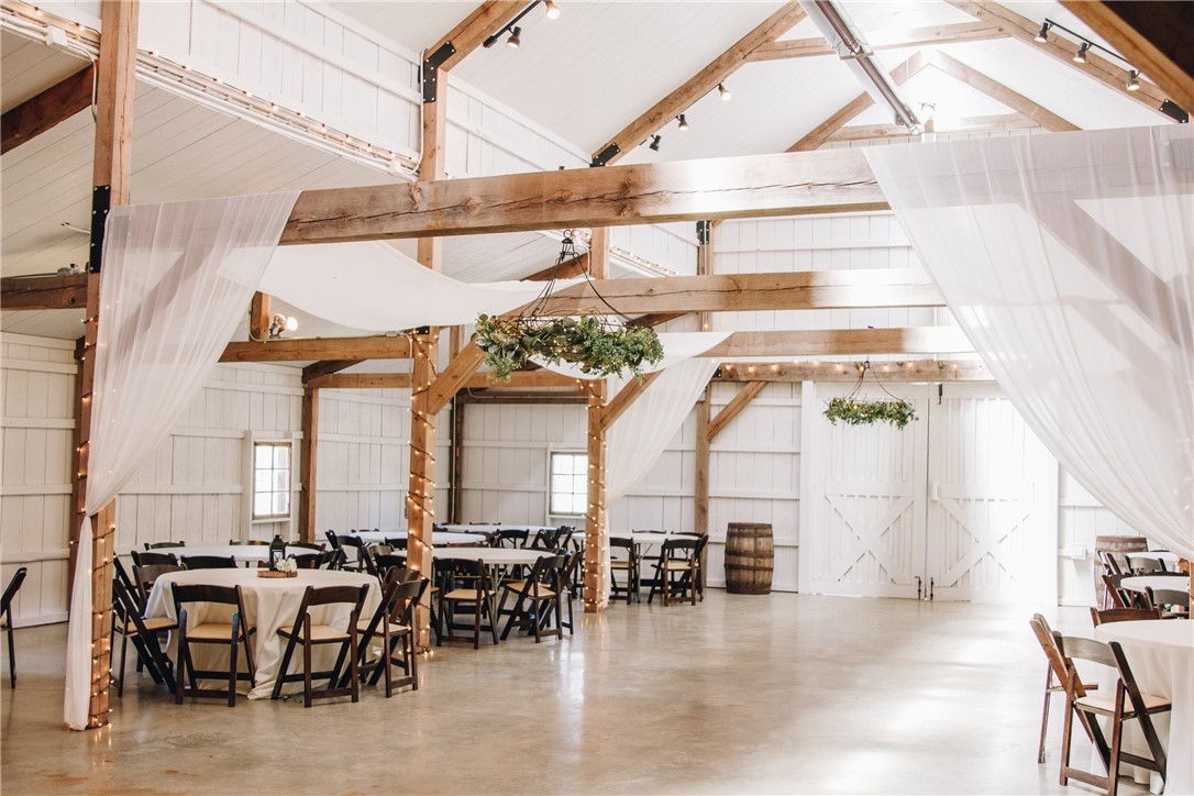 Wedding & Event Venue on 7 Acres in Highfill Featuring a 4,416 sq ft barn and 1,478 sq ft wedding chapel, this property offers a stunning setting for weddings and events. Located in one of the fastest growing communities in Arkansas and only 3 miles from NWA Airport, it provides both privacy and unmatched convenience. Highlights: New white interior paint (2024), elegant chandelier (June 2025), wooden padded chairs (2024), bridal suite with new furniture & wooden countertop (June 2025), HVAC (2022), radiant heat (2020), insulated ceilings, and spacious indoor/outdoor areas. Venue featured twice and aired on TLC, and published in USA Today magazine (Nov 2015). A rare opportunity to own a turnkey venue in Northwest Arkansas, blending rustic charm with modern updates.