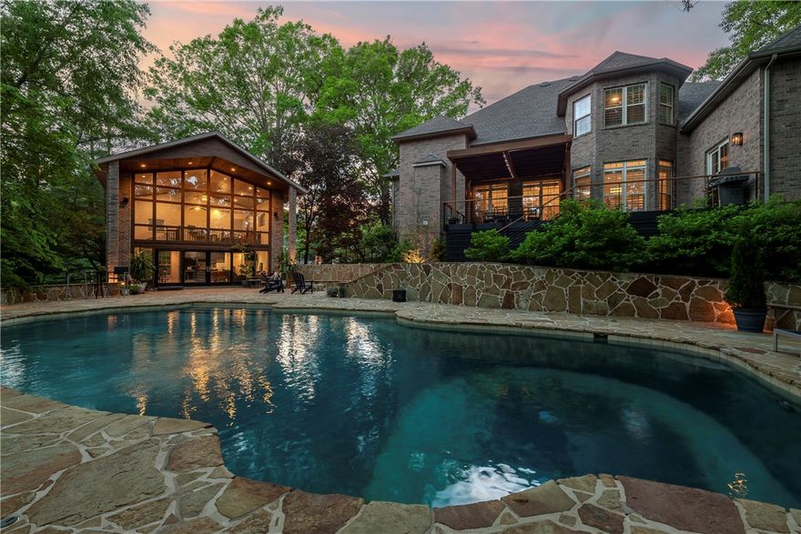 This rare find sits in the highly desirable North Bentonville Heathrow neighborhood. This unique property has an unbeatable location, a serene backyard oasis with a saltwater pool, and a poolhouse with an additional loft bedroom, kitchen, bathroom, & even more living space. The owners have meticulously remodeled and maintained this property and spared no expense not only the items you could see, such as the kitchen and baths, refinishing 1 1/2"  hardwood floors, and much more but also those items you can't see, such as HVAC units, water heaters, roofs, etc. on both structures. In addition, new pool equipment, an efficient, rapid-heat pool heater, new composite decking with Pergola, and much more make this home move-in ready!  Situated on the Razorback Greenway on nearly 2 acres, enjoy your privacy without sacrificing convenience and enjoy all of Bentonville has to offer!