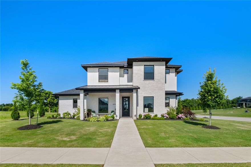 Elegant luxury meets thoughtful design in this executive home. The corner lot home in gated SV backs up to the 14th green & lake & is caddy corner to the 15th tee for views all around. The home is bright & airy with 43 windows & tall ceilings. The gourmet kitchen boasts Cafe appliances, quartz counters & display cabinets. Adjacent find a dry bar & butler pantry. Enjoy the primary suite with his & her designer closets, walk in shower & soaking tub. Rounding out the downstairs is a dining room with accent walls, custom office with privacy doors & open family room with a wall of glass windows/doors to enjoy the view. Upstairs find a bonus room with wet bar, 3 spacious bedrooms with Jack&Jill & ensuite designs. Enjoy  the expanded patio with gas FP overlooking park like landscaping and golf course views. 3-car garage with epoxy floors, security system, B'ville schools, & thoughtful storage are a few additional highlights. This home offers the best of luxury, function & location. Reach out for full features sheet.