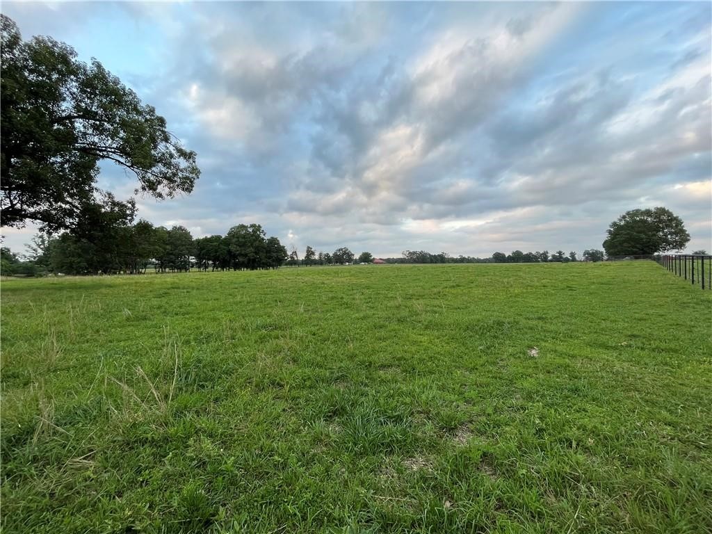 Build your dream home with elbow room for a shop! This country setting is peaceful and quiet but area still boasts top end estates. Property follows Pepper Hills covenants (2500 sq ft min) with exceptions but is not inside the subdivision. Metal shops allowed; everyone needs a shop! Electric off southwest corner of property, 8" Highfill water main at southeast corner where pavement ends (great water and pressure), Cox fiber box at southeast corner. More acreage available. Can do a driveway drive by but do not drive into pastures without appointment or up to home at end of road. Property is agent owned. Corners will be loosely marked with orange flags
