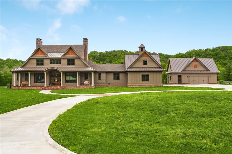 Your dream home is already finished! This custom Southern Living style estate sits on 5 private acres with incredible creek frontage, yet 5 minutes from downtown Bentonville. You’ll fall in love with the open living area with detailed ceilings & beams & beautiful oak wood floors throughout. This space is made for entertaining with 3 dishwashers, 3 ovens, 3 fireplaces, 4 master bedrooms, plus a bunk room; office space, two bonus rooms over both heated/cooled garages, & more! You won't find anything better!