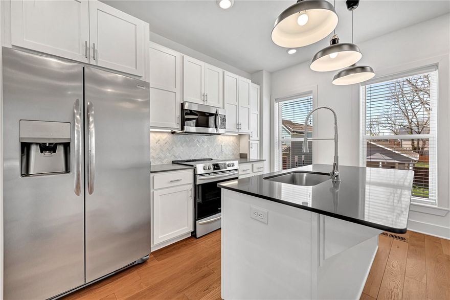 AMAZING OPPORTUNITY TO LIVE IN THE HEART OF DOWNTOWN BENTONVILLE!! This gorgeous 2 bedroom/2 full bath townhome is nestled just one block from Skylight Cinema, The HUB Bike Lounge, Pedaler’s Pub and just ½ a mile from Bentonville’s City Square providing a short walk to shopping, dining, First Friday, Farmer’s Market, live music, scenic trails, nightlife and more! This 3 level luxury residence provides a wonderful layout starting with the first floor offering a generous sized bedroom, full bath and attached garage for parking and bike storage. The second floor hosts open concept living with a sleek kitchen, sun filled living space and dining area. The top floor is home to the primary suite with full bath, laundry and a walk-out balcony! Amenities include stainless steel appliances (refrigerator conveys), quartz counter tops, hardwood flooring, full tile surround showers and more! Fabulous opportunity for an investment property or make this downtown beauty your primary residence!